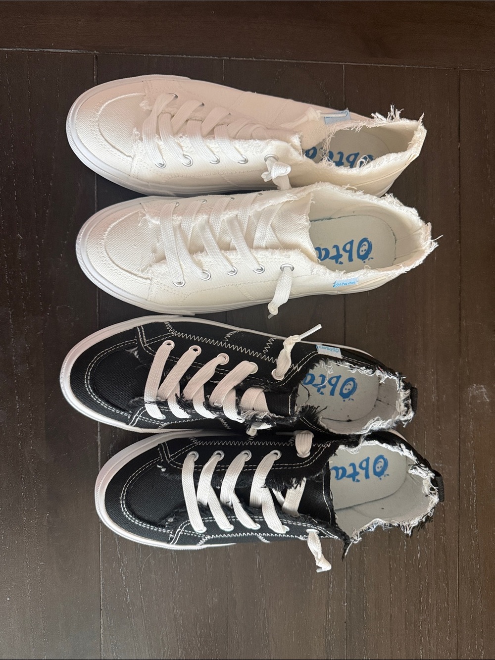 White and black pair of sneakers for woman